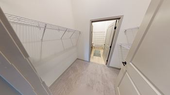A staircase with a metal railing leading to a doorway.